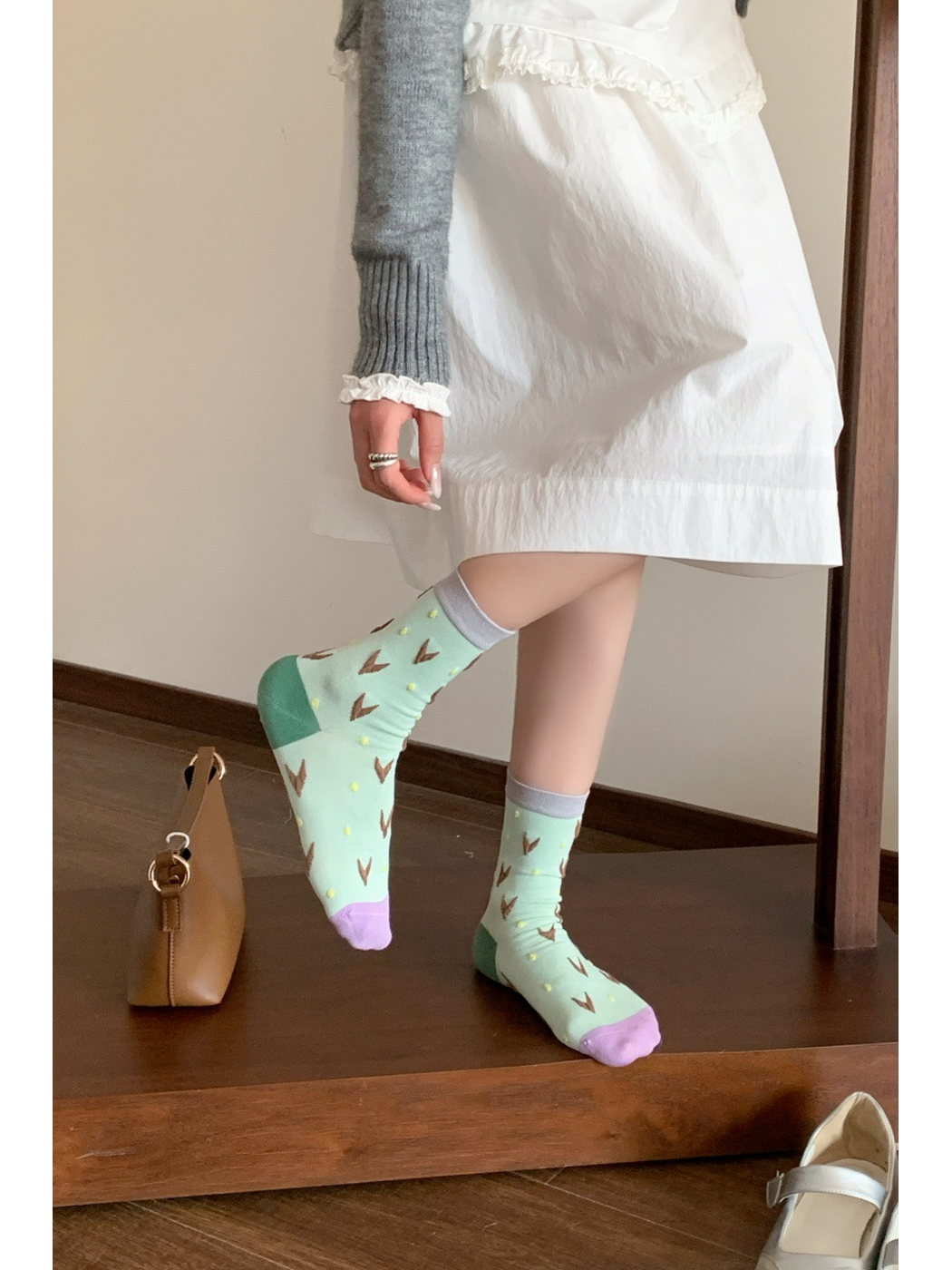 Mint patterned crew socks worn with contrasting toes and heels visible