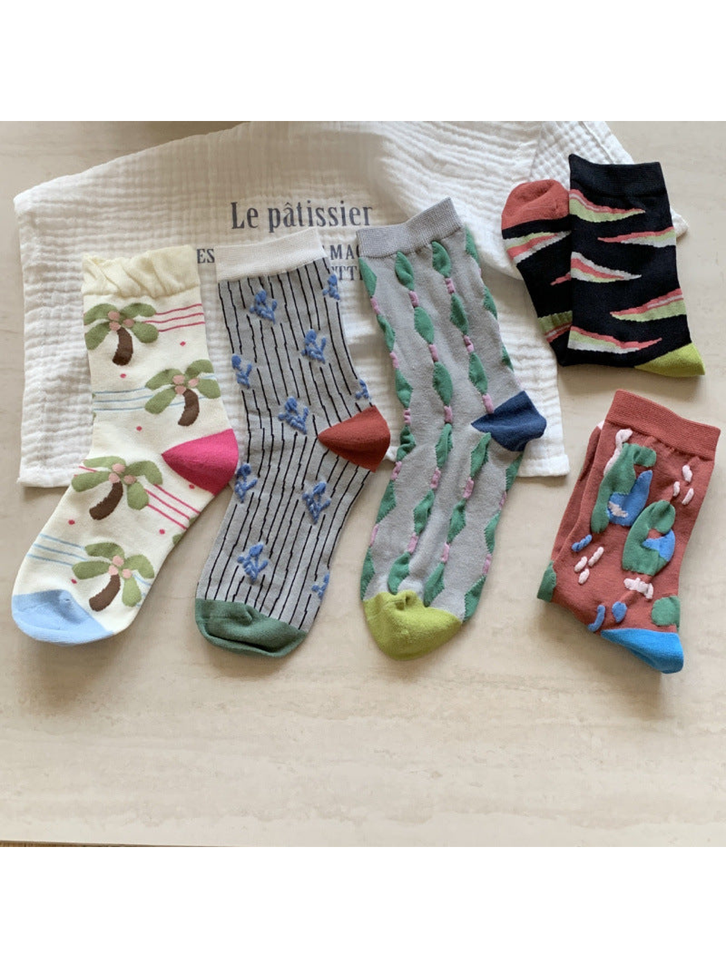 Five colorful patterned crew sock styles displayed together