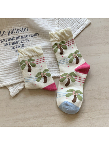 Ivory crew socks with palm tree motifs and ruffled cuffs