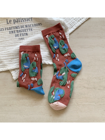 Brick-red crew socks with raised multicolor abstract motifs