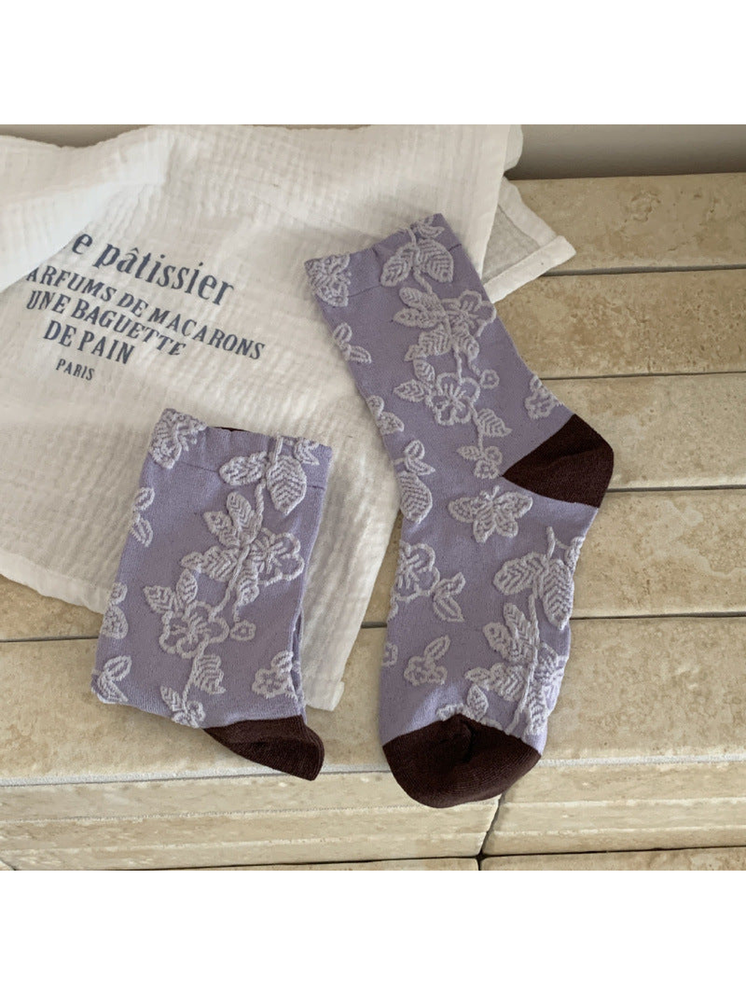 Light purple floral and butterfly crew socks with dark brown toe and heel panels