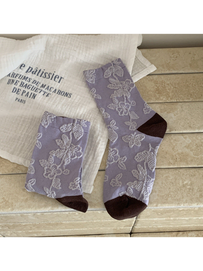 Light purple floral and butterfly crew socks with dark brown toe and heel panels