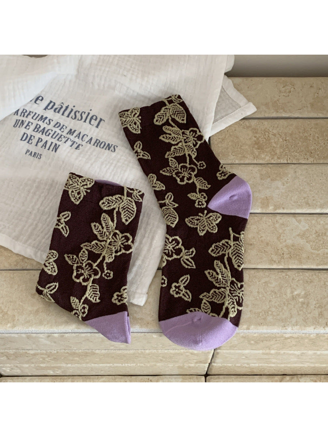 Dark brown floral and butterfly crew socks with beige motifs and light purple toe and heel panels