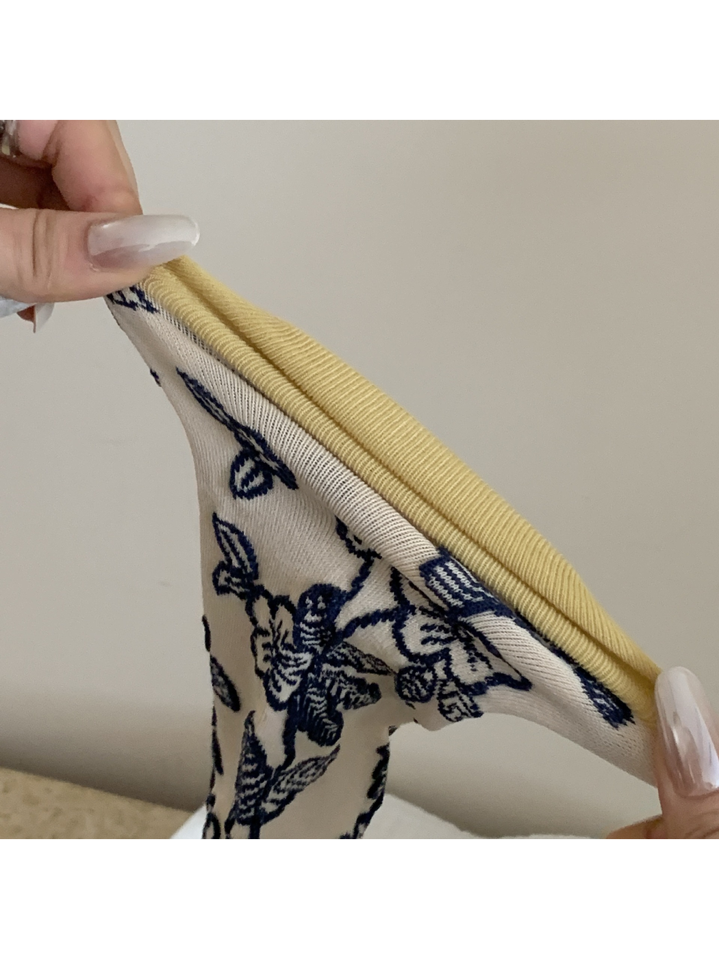 Close-up of the mustard toe panel and toe seam on the cream sock