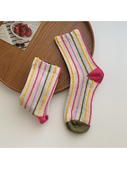 Ivory crew socks with raised multicolor stripes and olive toes