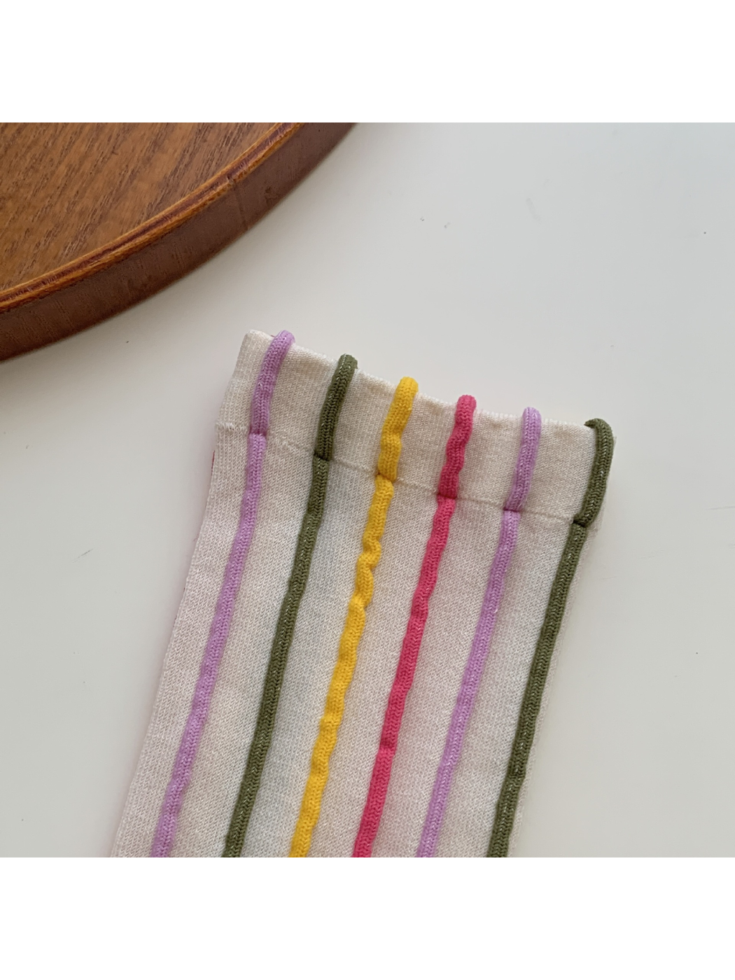 Close-up of raised multicolor stripes meeting the sock cuff