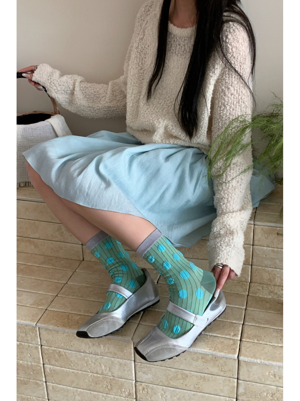 Green dotted crew socks styled with silver shoes