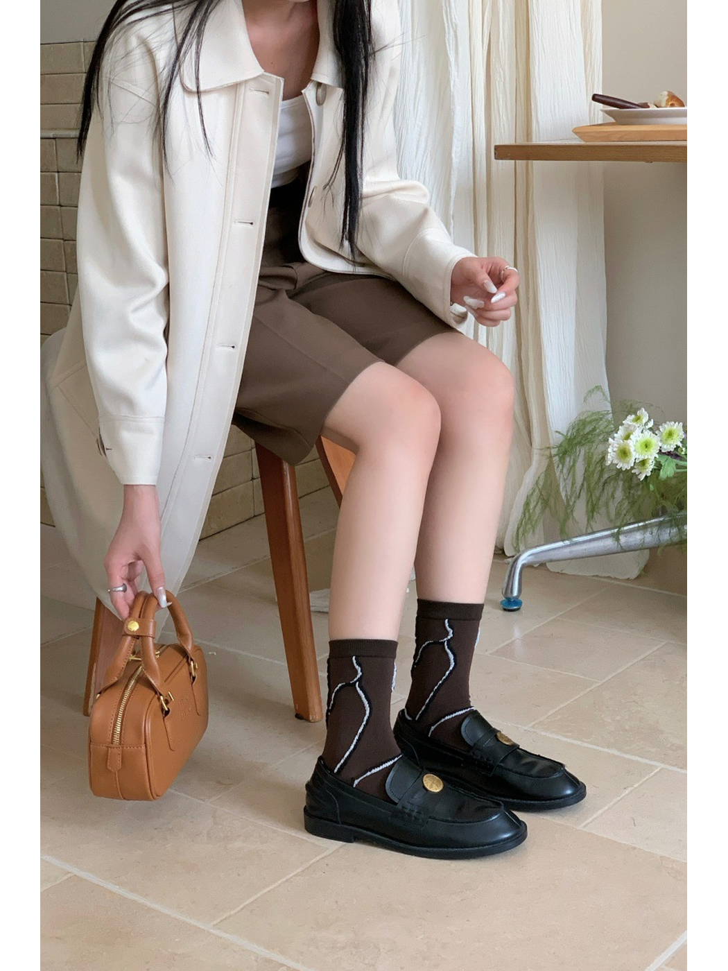 Dark brown abstract-pattern crew socks styled with black loafers