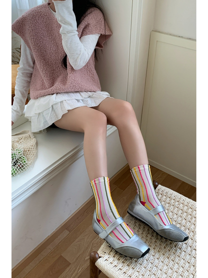 Ivory crew socks with raised multicolor stripes styled with silver shoes