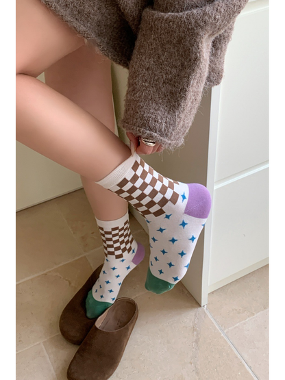 Checkerboard and blue star crew socks shown while worn