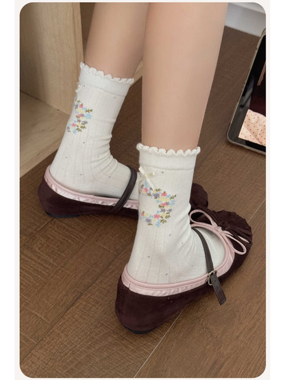Ivory floral wreath crew socks worn with burgundy flats