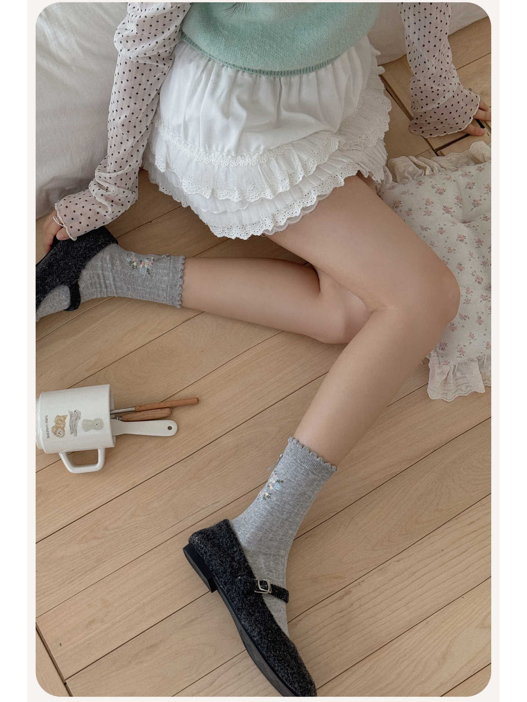 Gray floral wreath crew socks styled with black textured flats