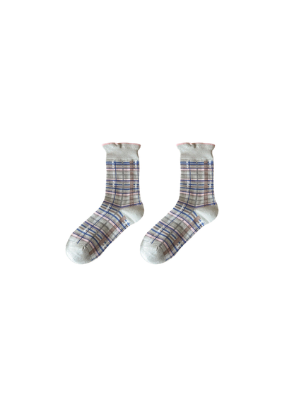 Gray plaid crew socks on a neutral background