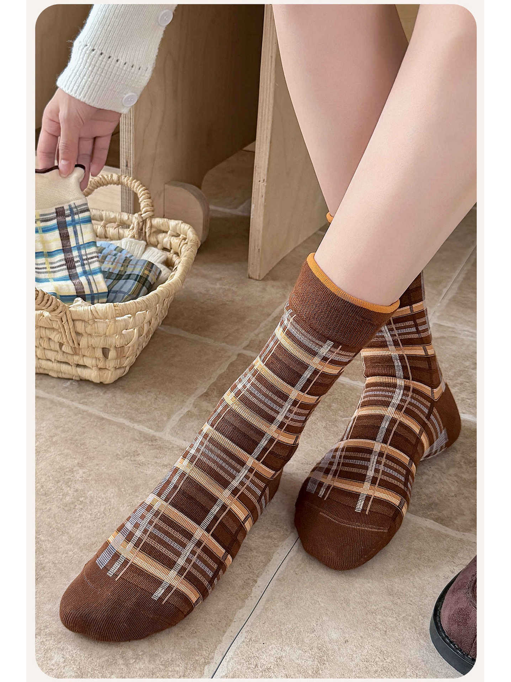 Brown plaid crew socks worn in a seated indoor setting