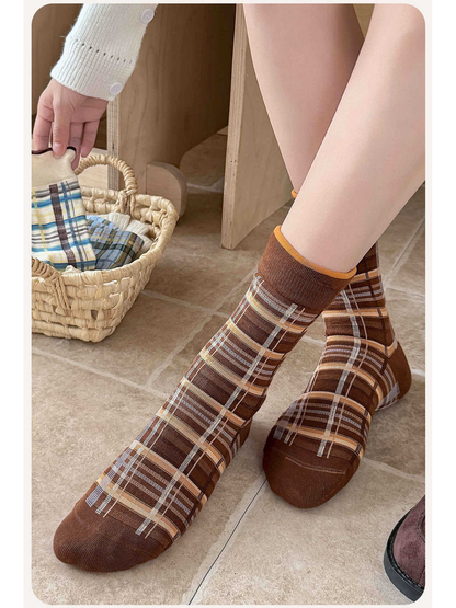 Brown plaid crew socks worn in a seated indoor setting