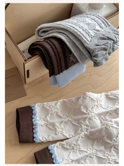 Close-up of folded patterned crew socks showing cuffs and raised textures