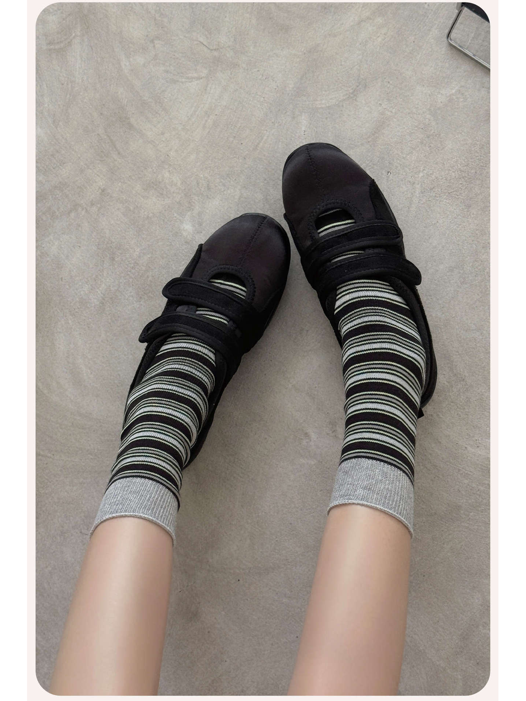 Black striped crew socks with gray cuffs worn with black shoes