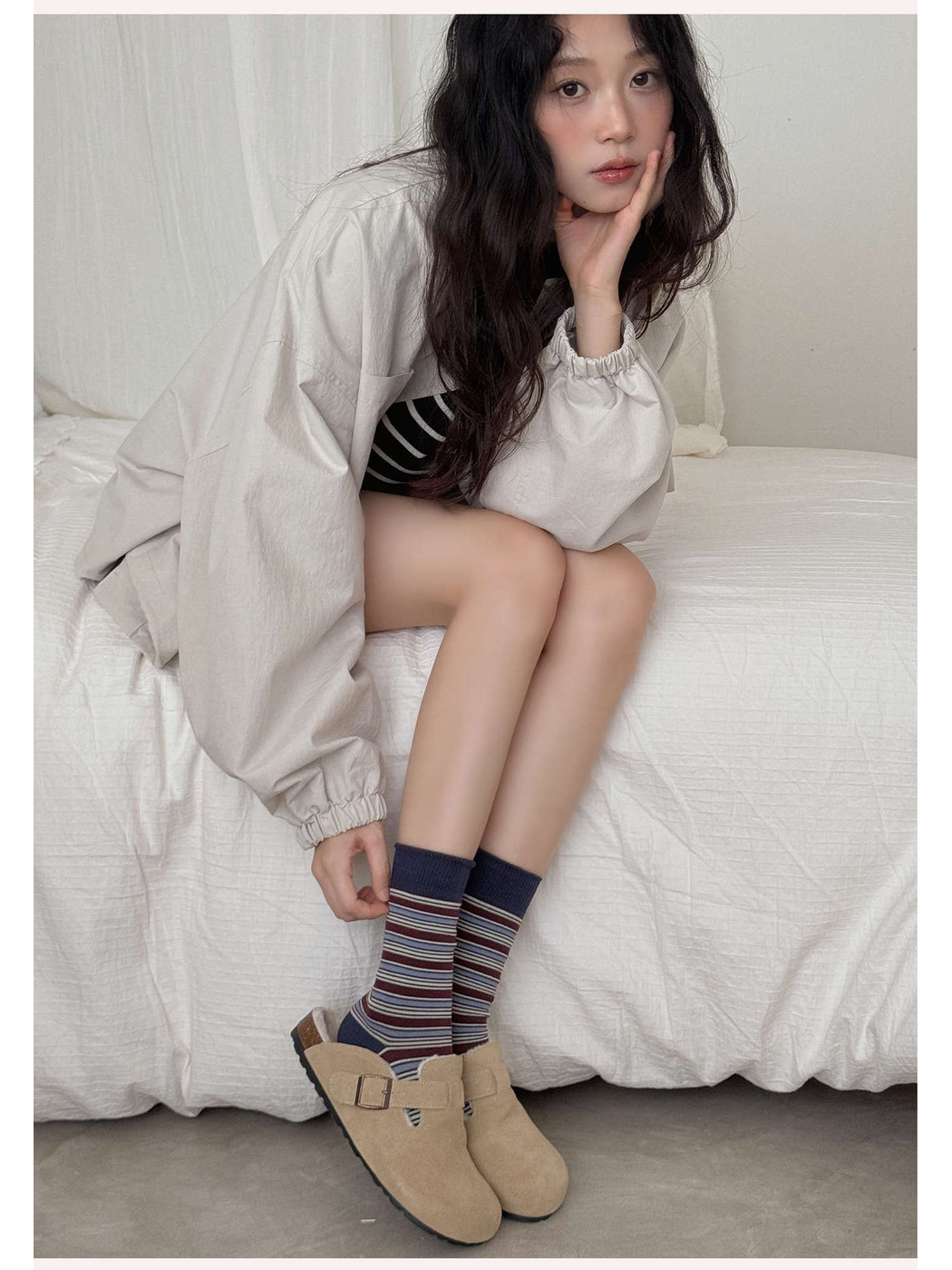 Burgundy and navy striped crew socks styled with beige shoes