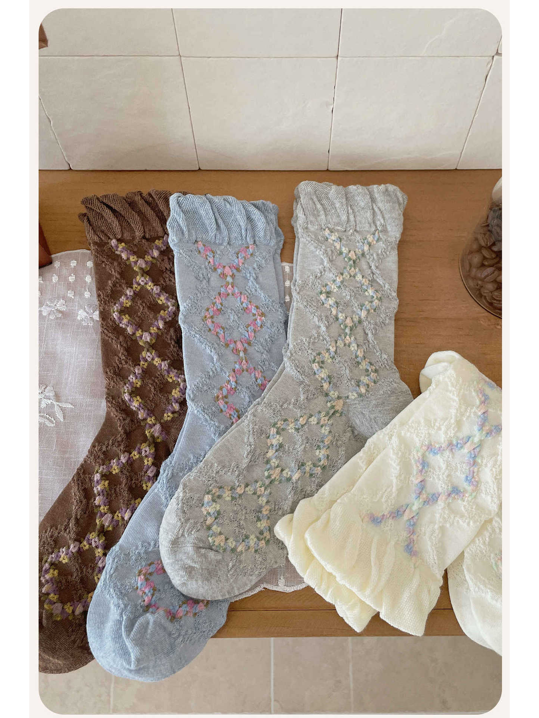 Brown, light blue, gray and ivory floral argyle socks in a close display
