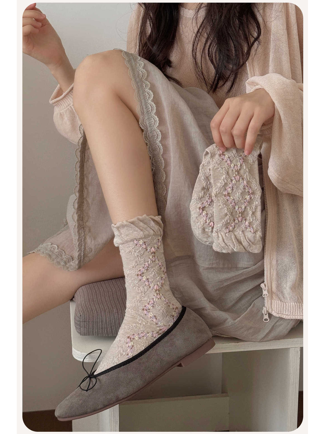 Beige floral argyle crew socks worn with gray flats
