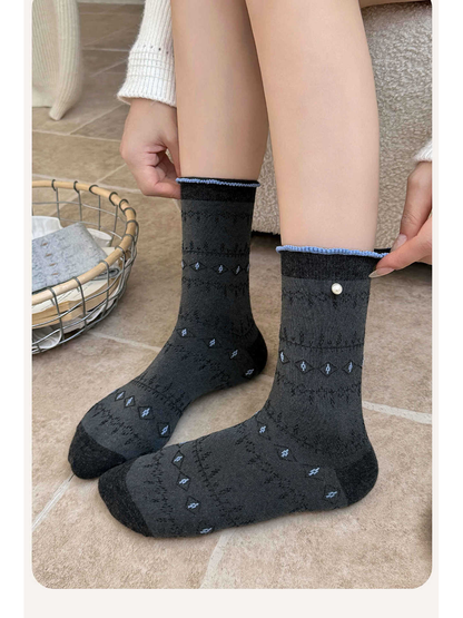 Black and gray pointelle crew socks worn without shoes