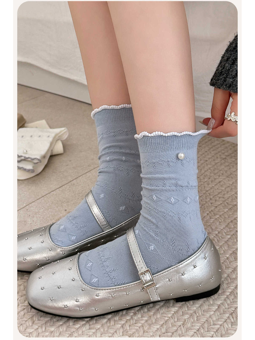 Light blue pointelle crew socks styled with silver Mary Jane shoes
