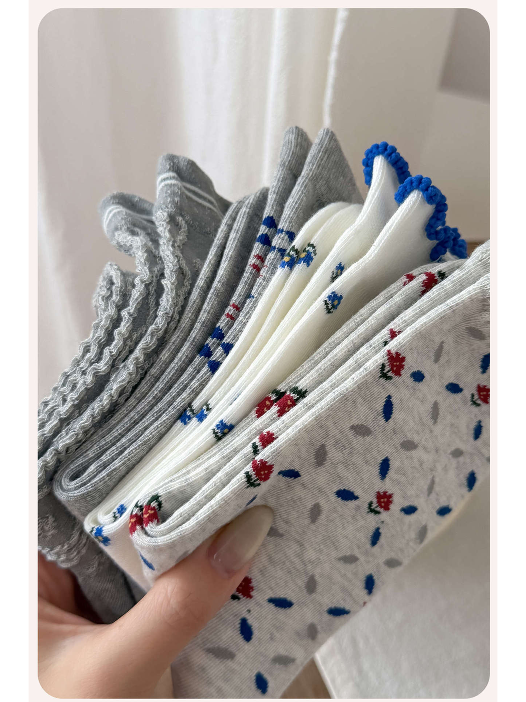 Close-up of folded gray and ivory patterned crew socks