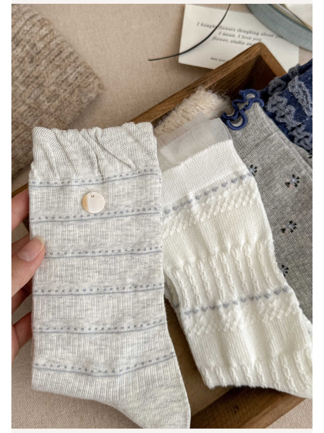 Close-up of light gray striped and white textured sock cuffs
