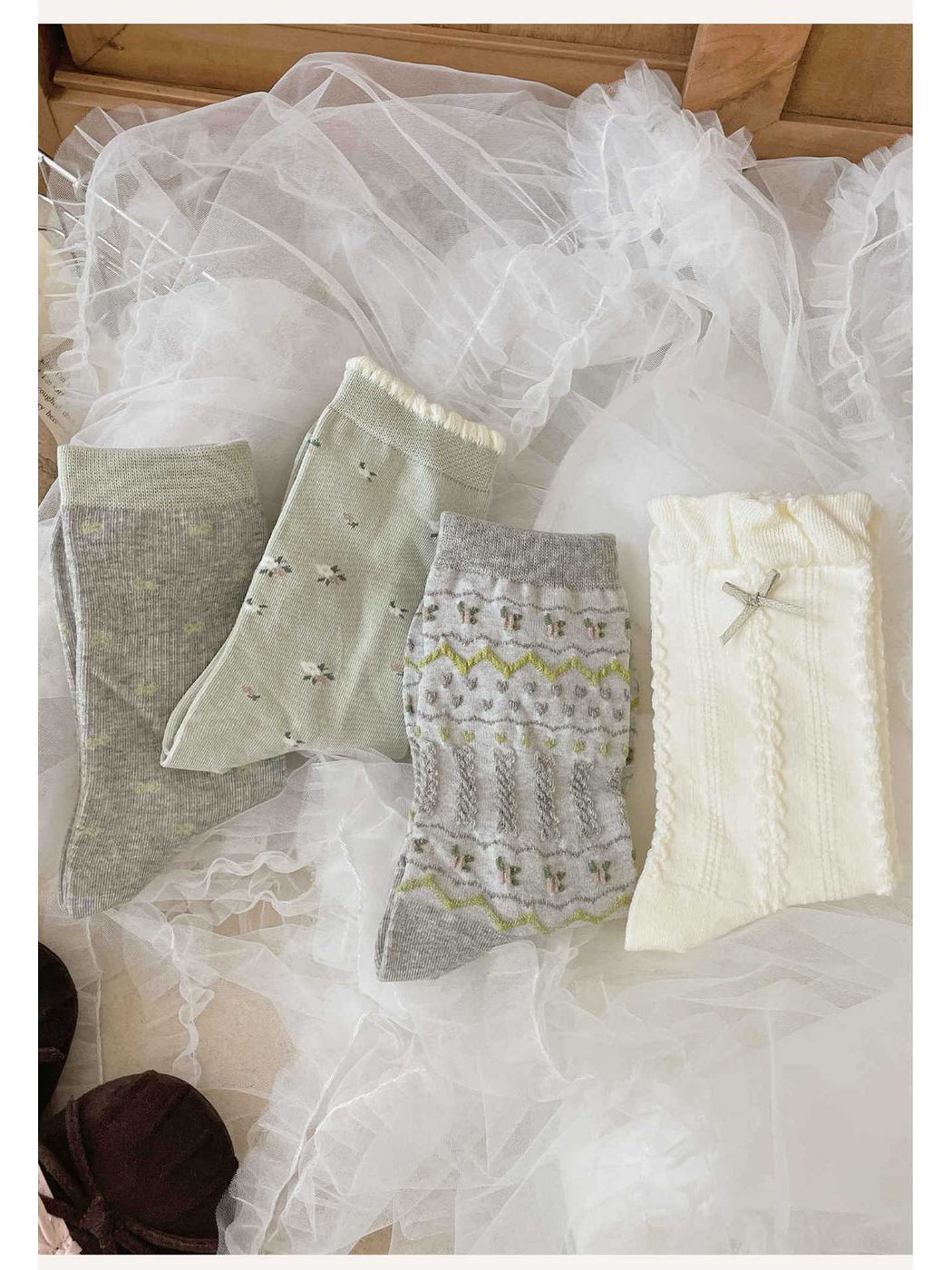 Four crew sock designs arranged on white ruffled fabric