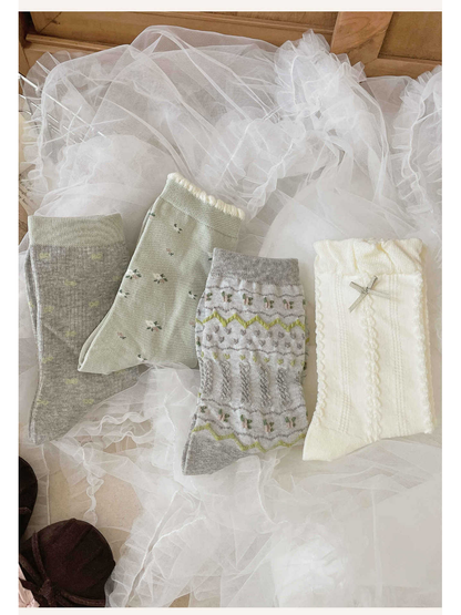 Four crew sock designs arranged on white ruffled fabric