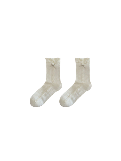 Ivory crew socks with ruffled cuffs, bow accents and openwork panels