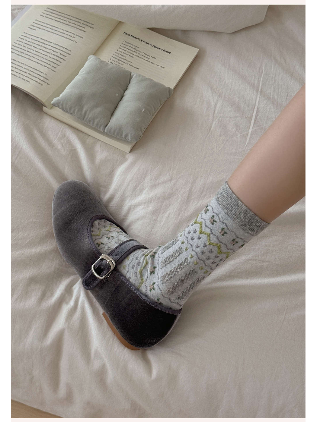 Light gray geometric crew sock worn with a gray buckle flat