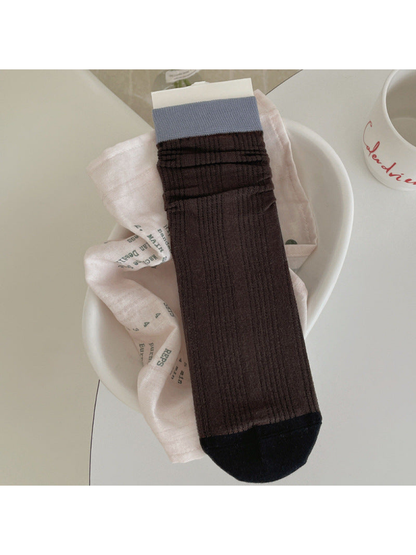Dark brown ribbed crew sock with light blue cuff and near-black toe
