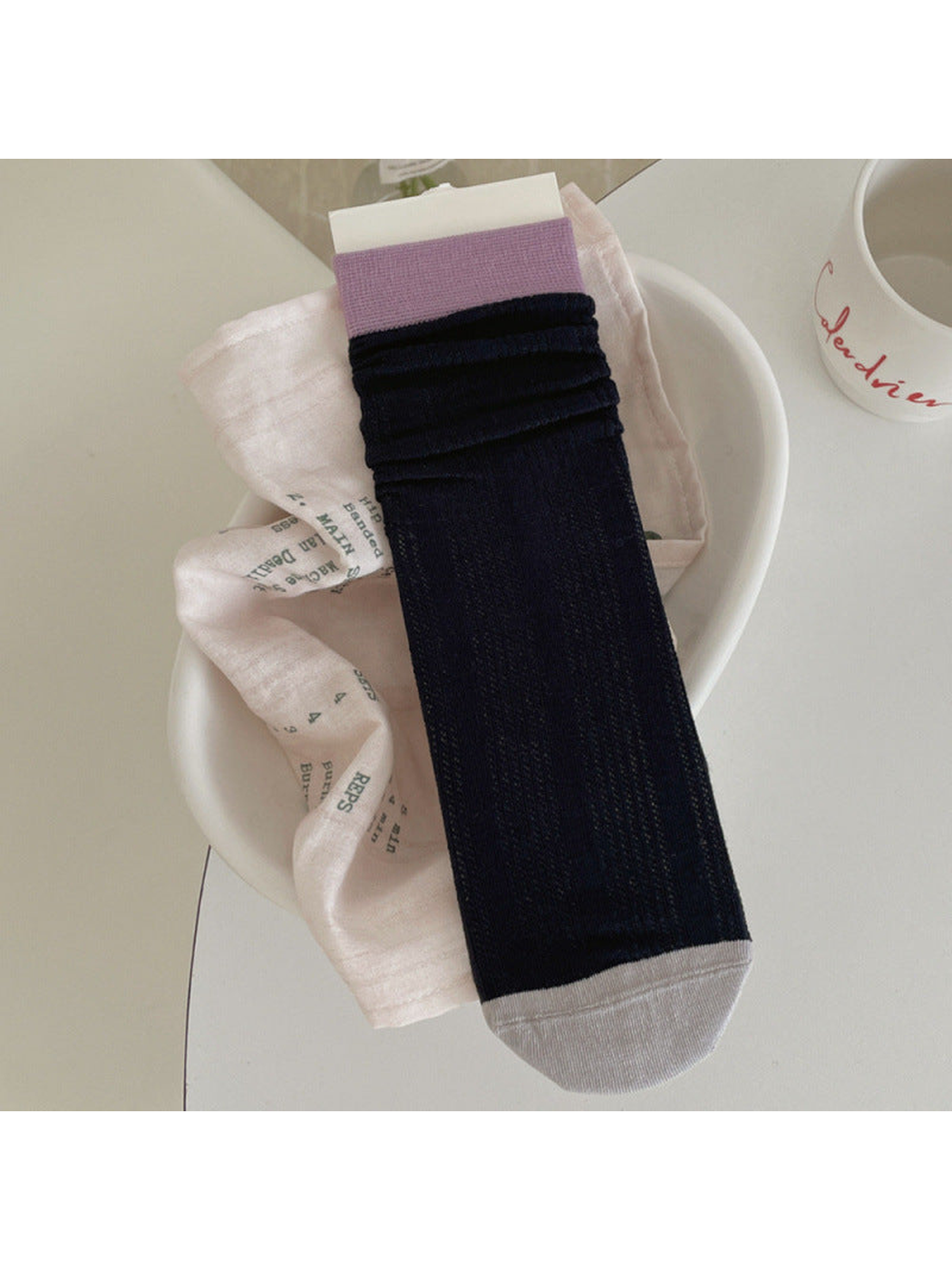 Navy ribbed crew sock with light purple cuff and light gray toe