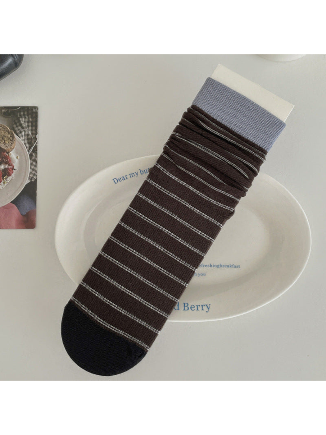 Brown striped crew sock with light blue cuff and black toe