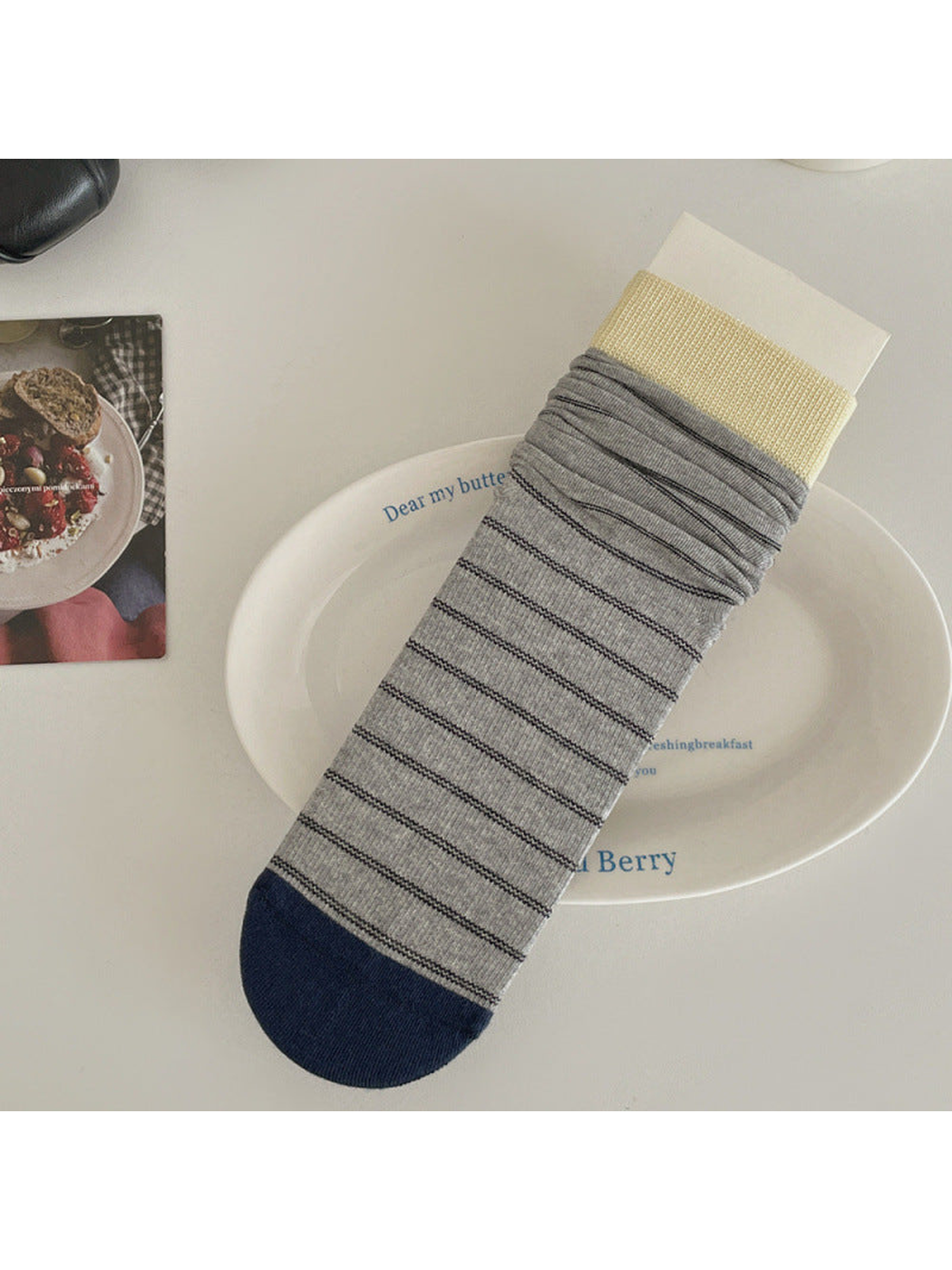 Gray striped crew sock with cream cuff and navy toe