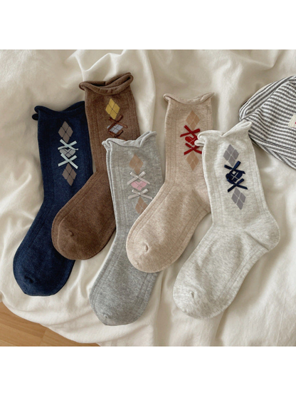 Mixed-color selection of five argyle crew socks with ribbon bows