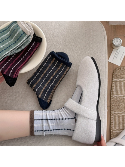White and navy striped crew socks styled with fuzzy Mary Jane shoes