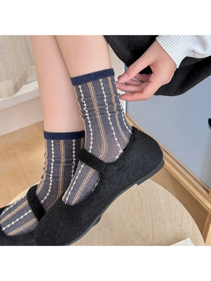Navy and brown striped crew socks worn with black Mary Jane shoes
