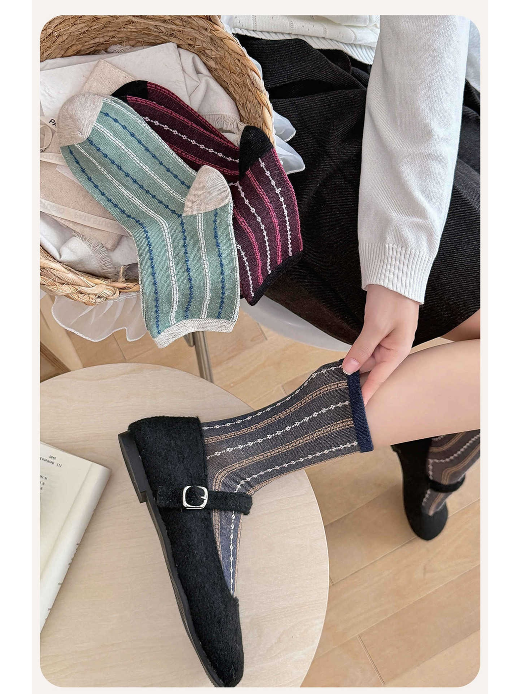 Navy striped crew socks styled with black Mary Jane shoes beside folded color options