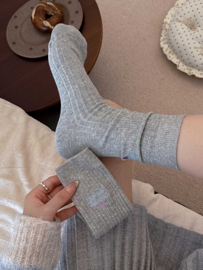 Light gray ribbed crew socks displayed from the side