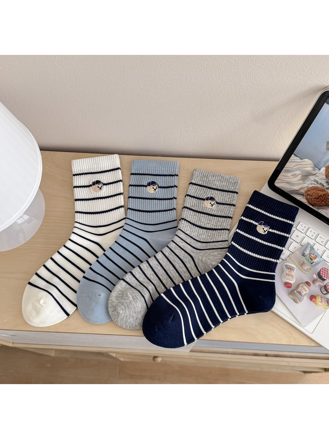 Mixed-color assortment of striped crew socks with embroidered dog motifs