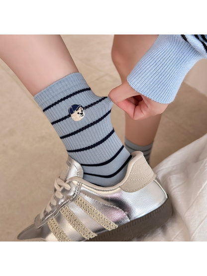 Light blue striped crew sock stretched at the ribbed cuff