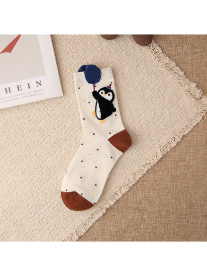 Beige crew sock with penguin and raised blue balloon motif