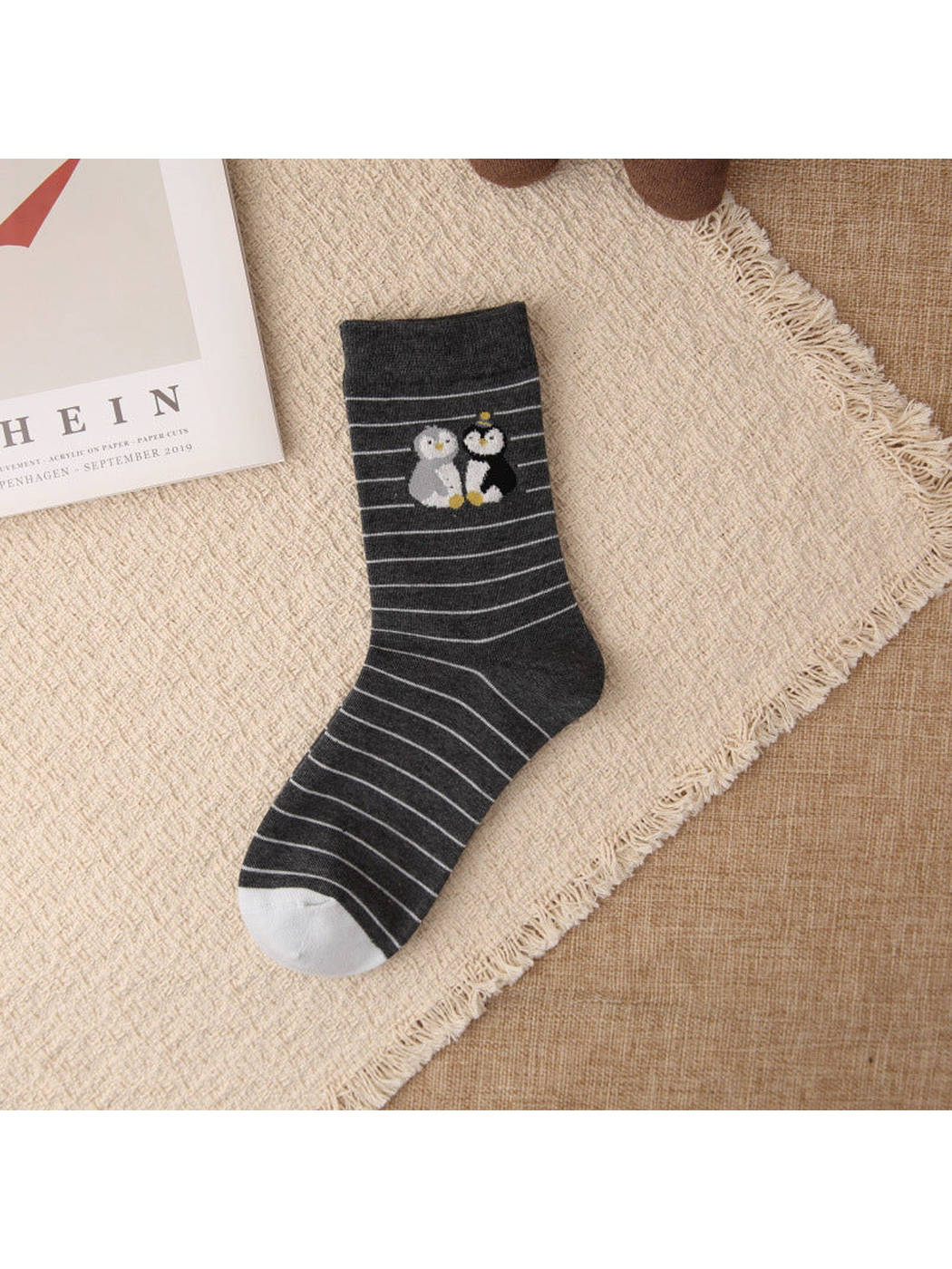 Dark gray striped crew sock with paired penguin motif