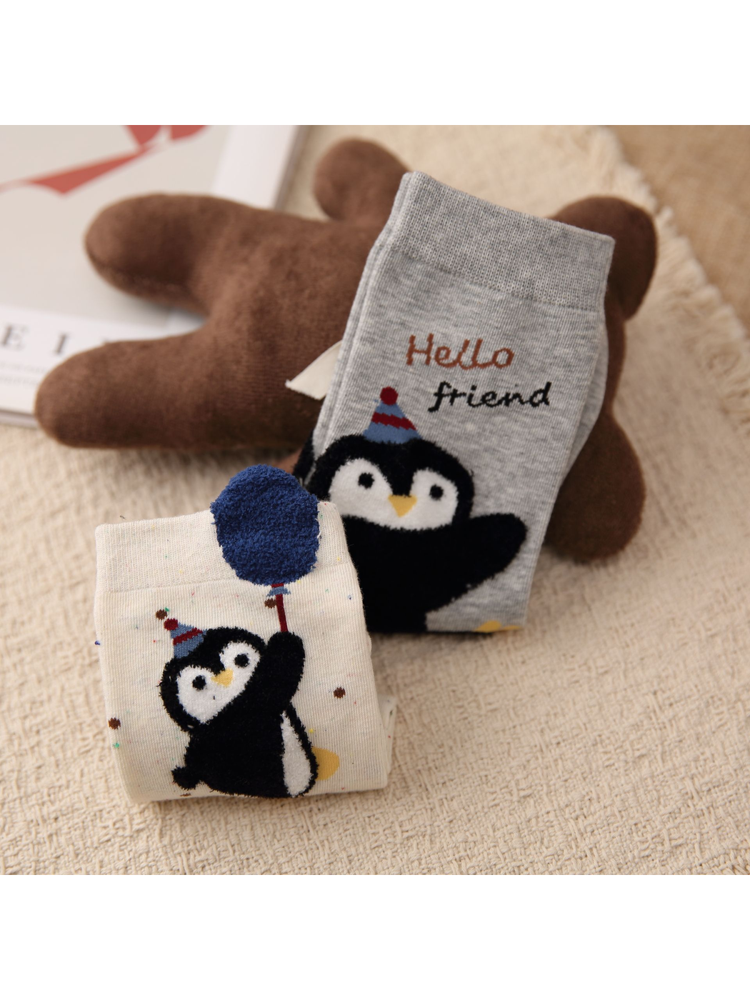 Close-up of fuzzy penguin appliques and raised balloon detail