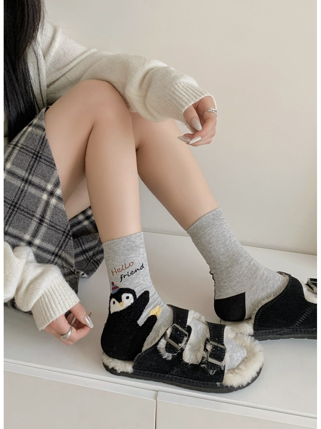 Light gray waving penguin crew socks styled with black sandals