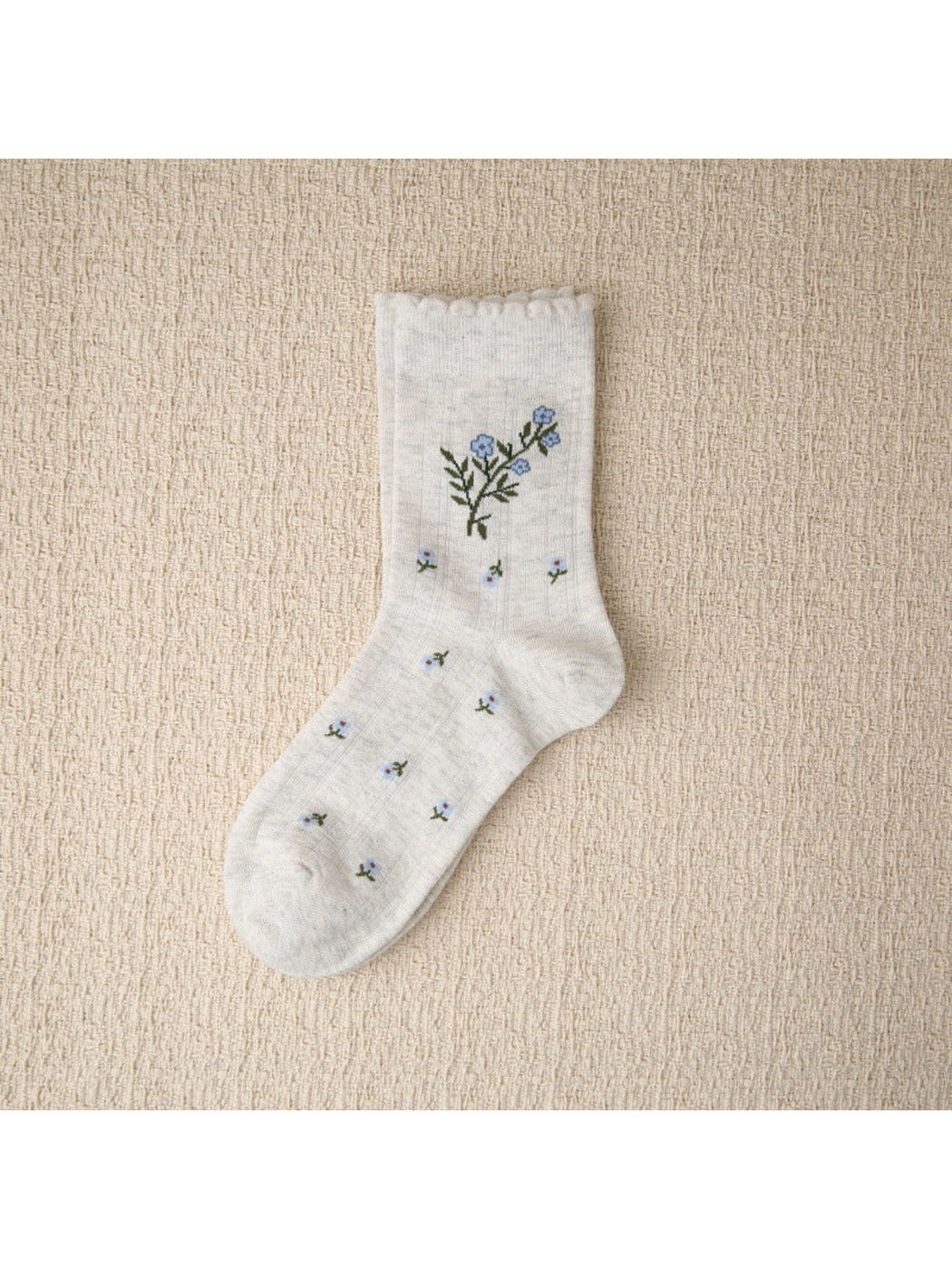 Heather gray crew sock with blue floral sprigs and scalloped cuff