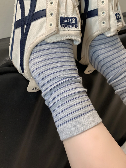 Light gray striped crew socks styled with white sneakers