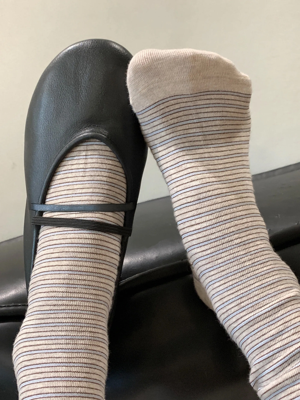 Beige striped crew socks styled with a black flat